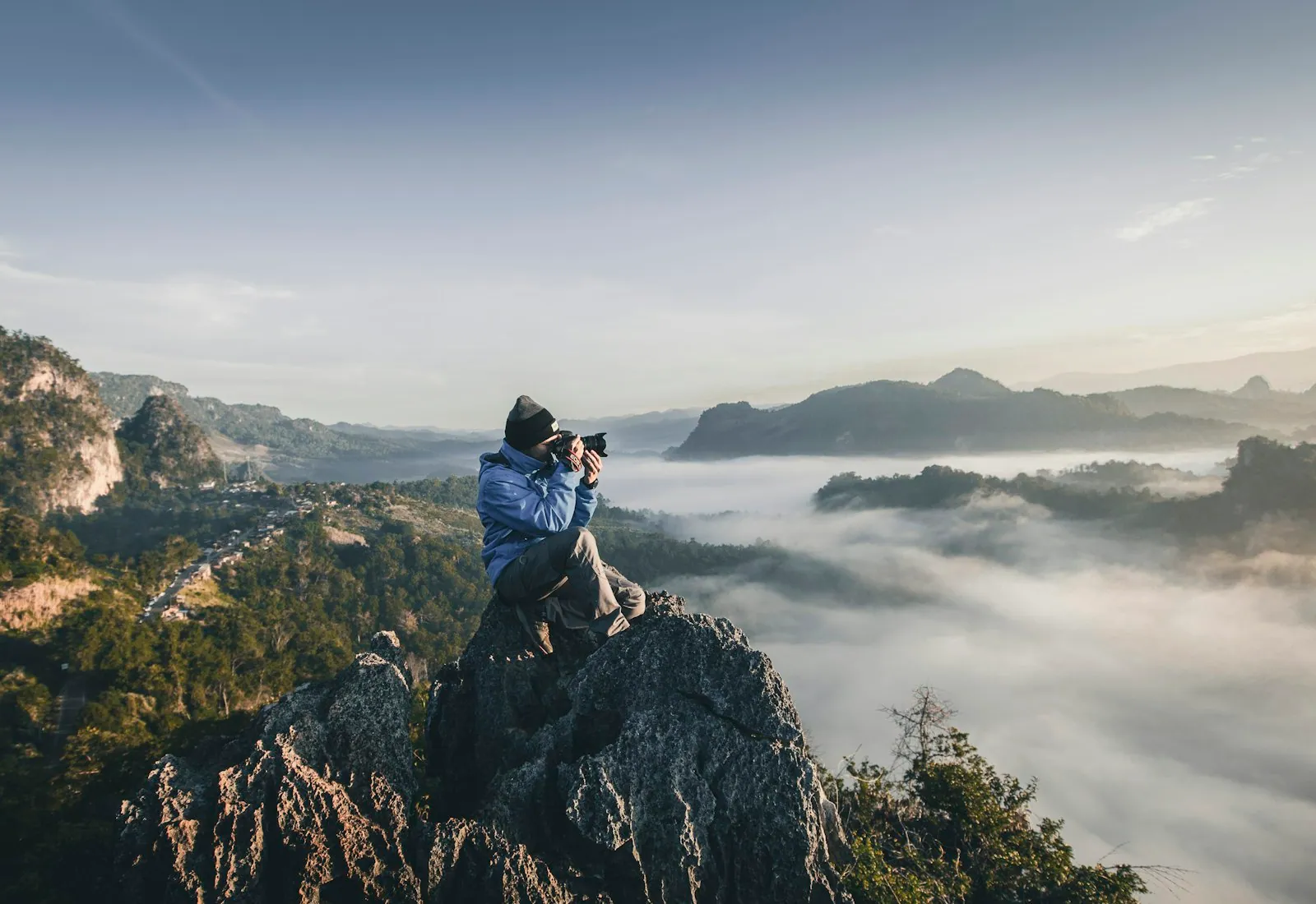 Travel creator photographing a ridge above morning cloud